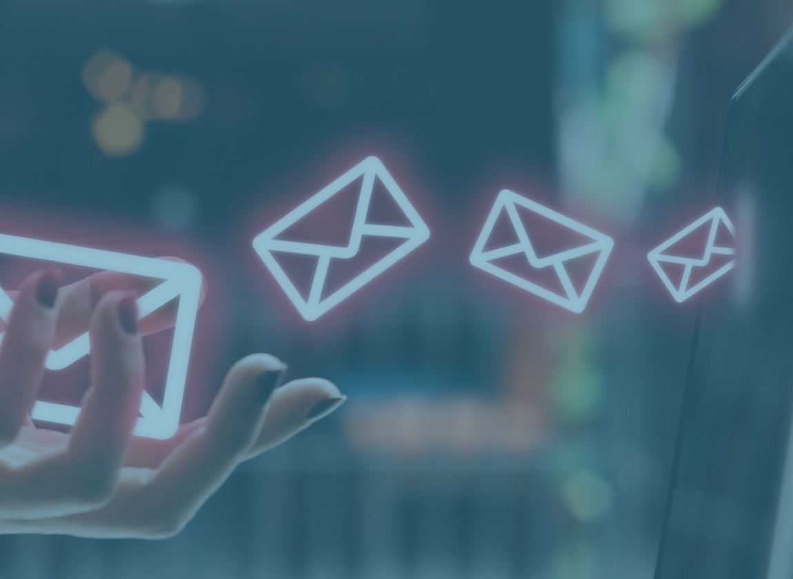 Woman's hand with email envelopes coming out of it and into a computer screen