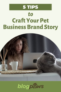 Woman at desk behind computer with grey cat on desk headline: 5 Tips to Craft Your Pet Business Brand Story