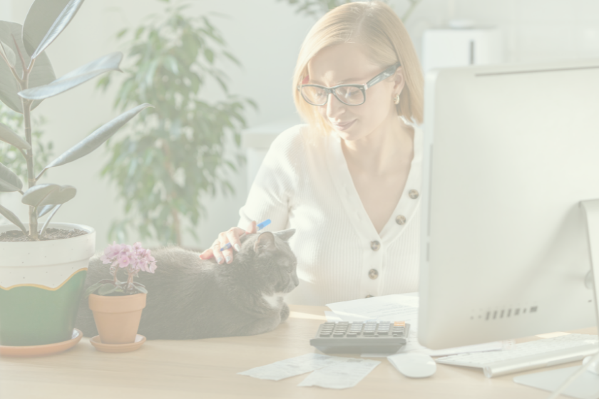 woman sitting in front of computer petting cat overlay | 38 Email Marketing Terms Every Pet Business Owner Should Know