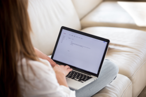 woman typing an email on laptop | Which Email Marketing Tool is Right For Your Pet Business?