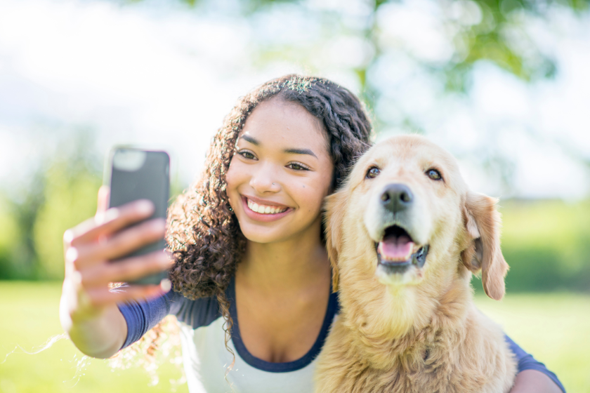 woman taking selfie with a dog | 10 Tips to Create an Instagram Editorial Calendar