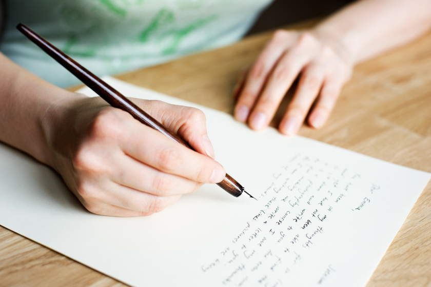 woman writing letter with a calligraphy pen | Letter to the BlogPaws Community: Tackling Burnout