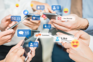 people using social media on their phones | How To Do a Social Media Audit