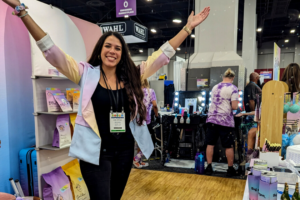 woman standing in a booth at pet trade show | Introducing the BlogPaws Best Award Winners at SuperZoo 2023