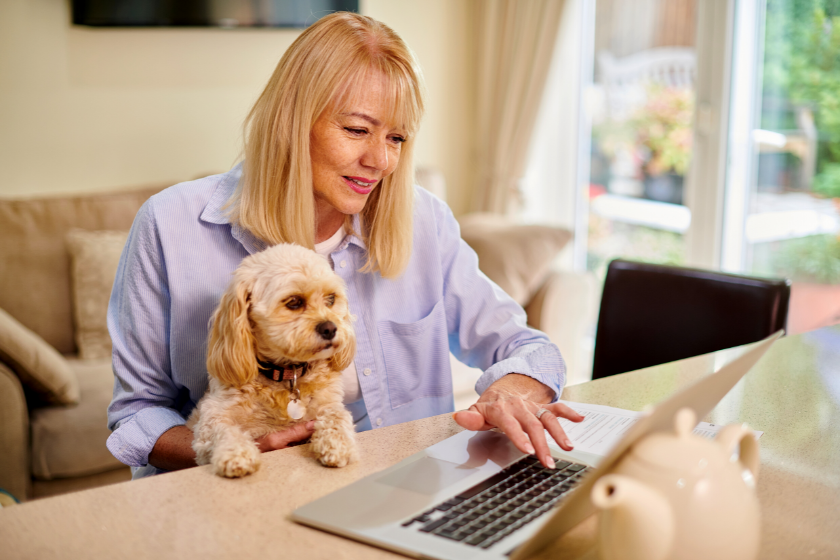 woman working at laptop with a puppy in her lap | Beginners Guide to Using Google Search Console for Keyword Research and SEO