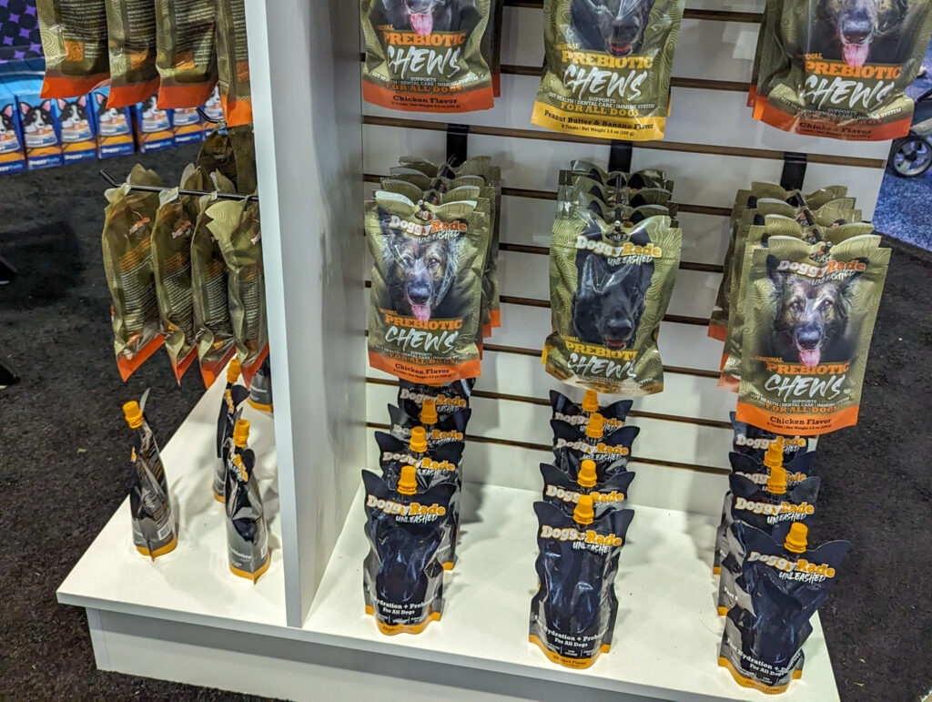 Black DoggyRade Unleashed pouches on display below pouches of prebiotic chews