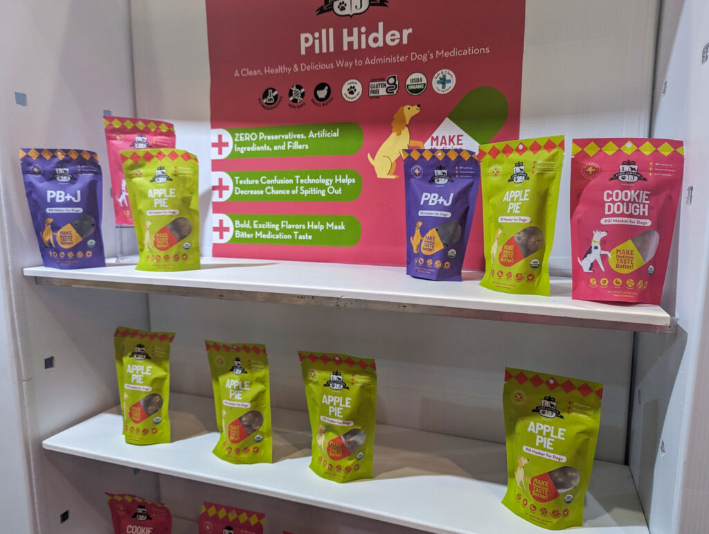 Pill hider packaging in PB+J (purple), Apple Pie (green), and Cookie Dough (pink)