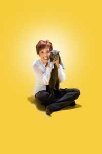 Mary Tan with cat on yellow background