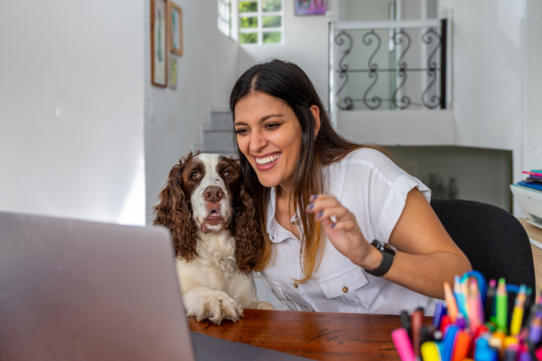 woman working at a computer with a dog next to her | How To Make Blogging Fun Again