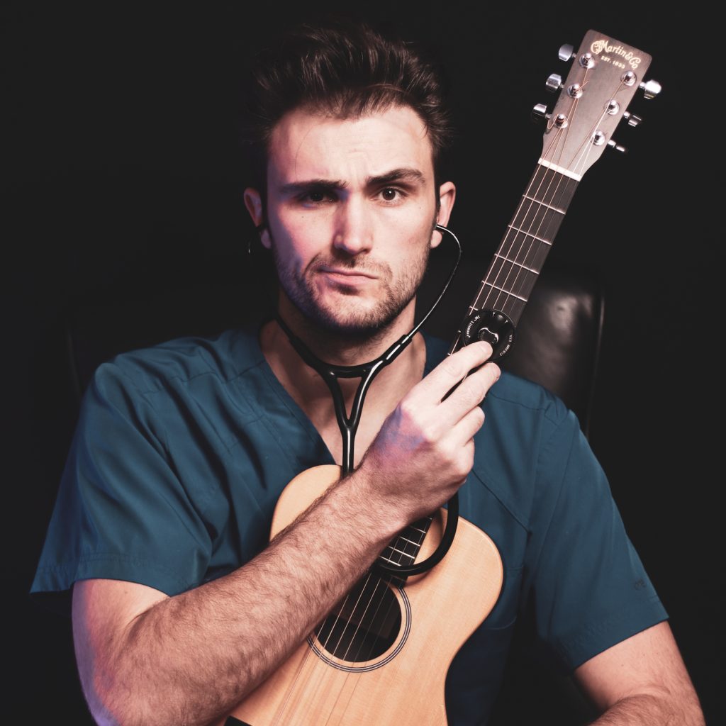 Dr. Ross Henderson with guitar