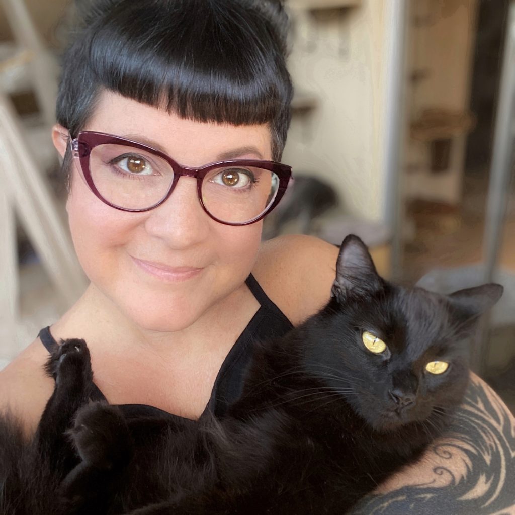 Kate Benjamin with her black cat