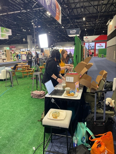 two women setting up a display at a trade show | The Pet Industry: Observations from Global Pet Expo 2025